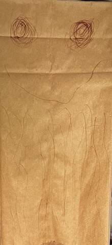 a child's drawing of a jellyfish on a brown paper bag